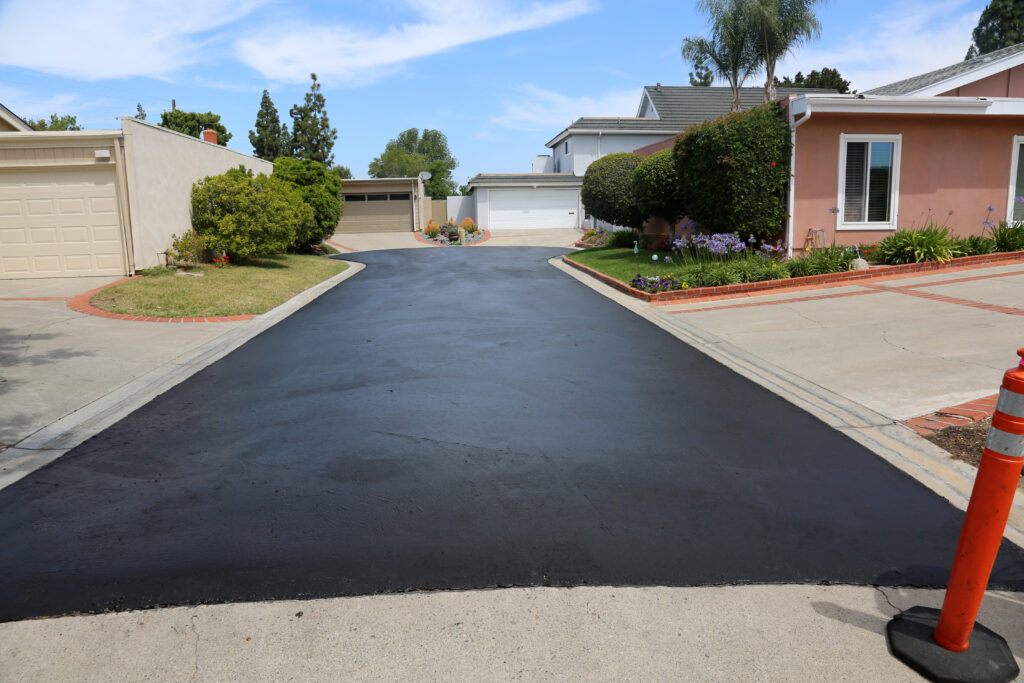 Freshly paved driveway in suburban neighborhood
