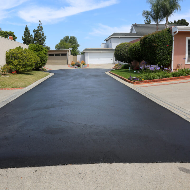 Freshly paved driveway in suburban neighborhood