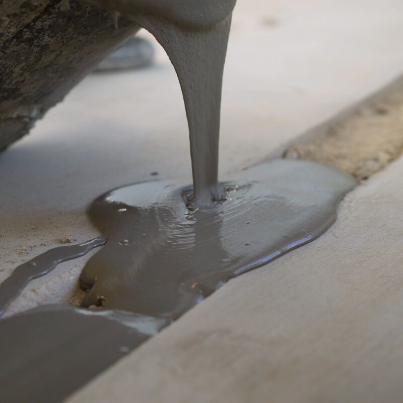 Wet cement poured into narrow groove