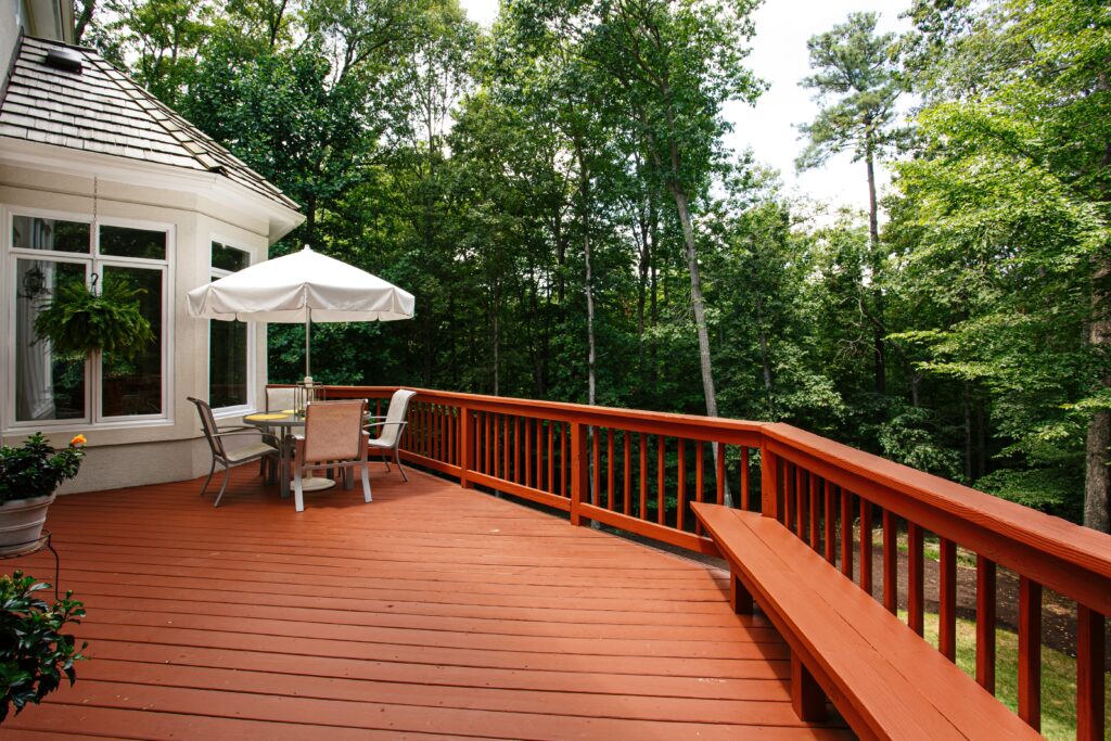 Outdoor deck with patio furniture and forest view
