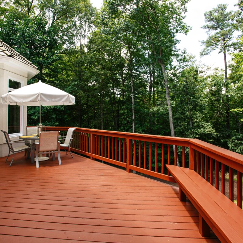 Outdoor deck with patio furniture and forest view